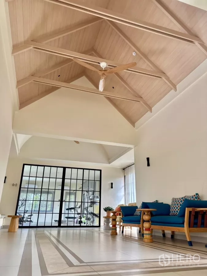 Detached House for rent in Lat Krabang, Bangkok - Clubhouse lobby with high vaulted wooden ceiling and lounge seating.