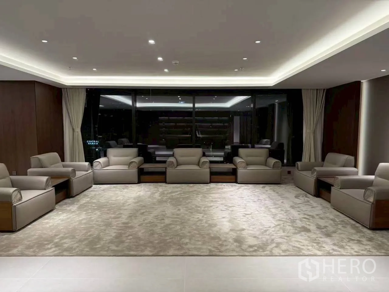Office Space for rent in Din Daeng, Bangkok - Large reception lounge with multiple armchairs and plush carpet facing full-height windows.