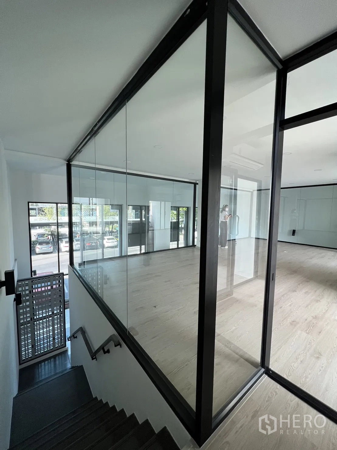 Home Office for rent in Bang Phli, Samut Prakan - Stairwell leading up to a glass‑walled office on the mezzanine level.