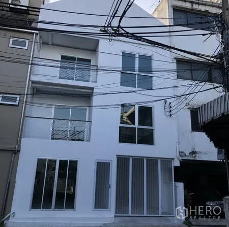 带办公室的家 出租在Khlong Toei, Bangkok - 现代白色多层商住两用外立面，设有大窗与临街整面玻璃。