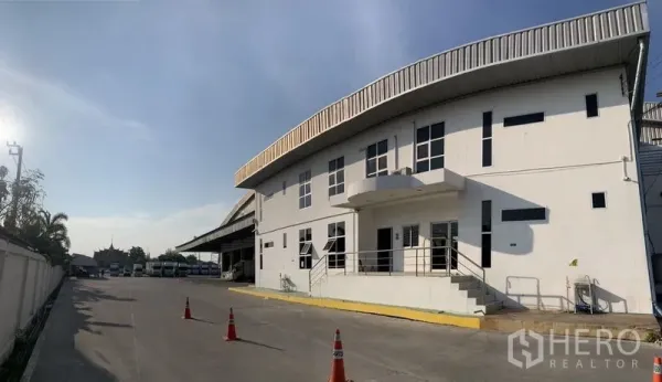 Warehouse for rent in Bang Bo, Samut Prakan - Front facade of warehouse office showing ramp access, parking area and truck loading bays.