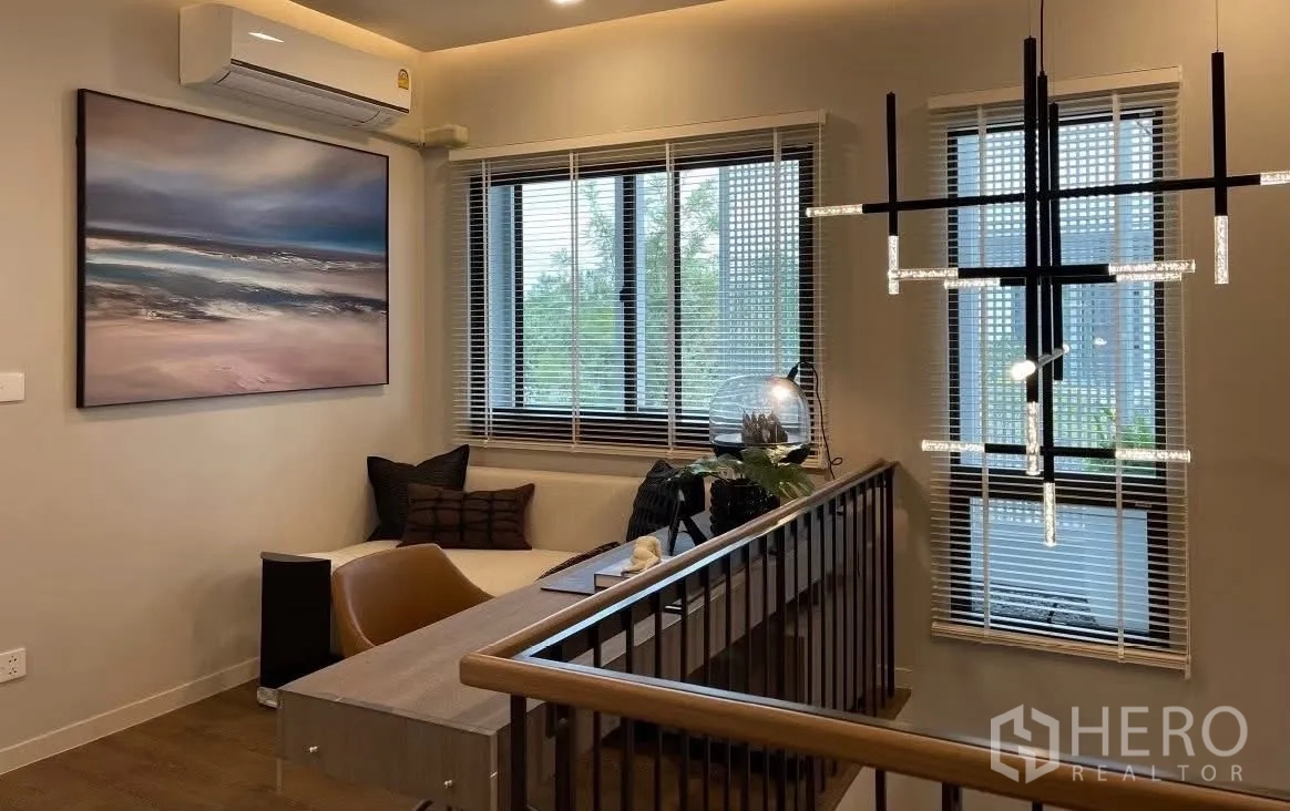 Detached House for rent in Bang Phli, Samut Prakan - Upstairs landing lounge with sofa, desk, and modern chandelier.