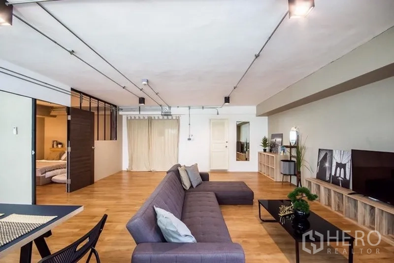 Home Office for rent in Phaya Thai, Bangkok - Open workspace with gray sofa, track lighting and sliding doors leading to a private room.