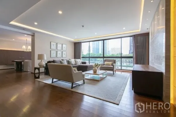 Condominium for rent or sale - Bright living area with panoramic glazing, neutral sofas and city views.