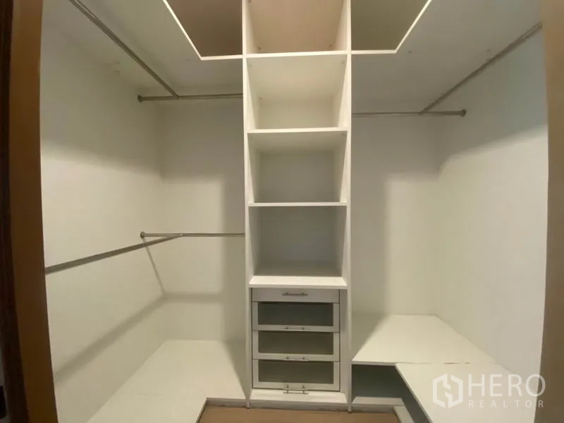 Condominium for rent in Sathon, Bangkok - Walk‑in closet with built‑in shelves, drawers, and hanging rails.