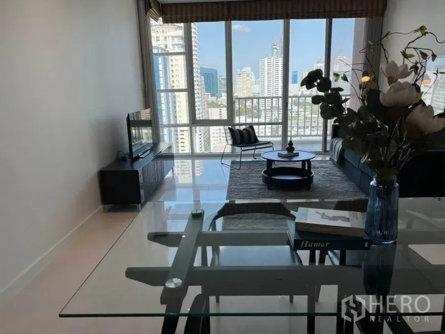 Condominium for rent in Watthana, Bangkok - Open-plan living area with large windows and skyline view from Sukhumvit condo.