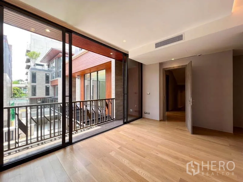 独立式住宅 出售在Yan Nawa, Bangkok - 卧室配宽幅推拉玻璃门，通往有檐阳台