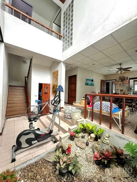Detached House for sale in Yan Nawa, Bangkok - Split-level interior with indoor planter, staircase and exercise corner.