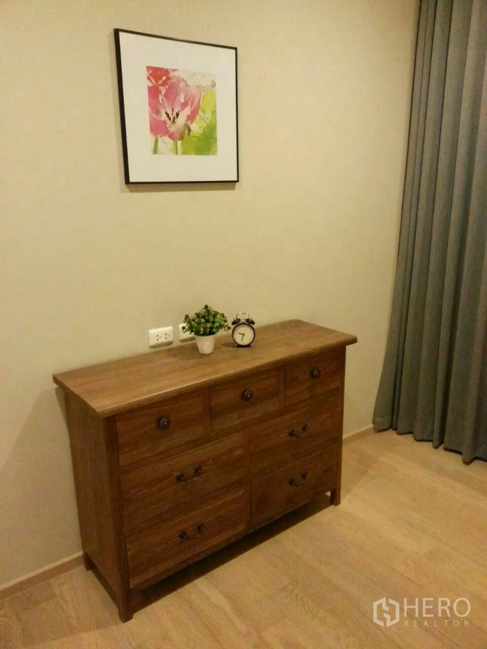 Condominium for rent or sale in Watthana, Bangkok - Bedroom chest of drawers with wall art and full‑length curtains in a calm neutral palette.