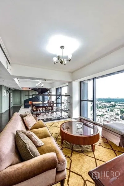 Condominium for rent - Corner lounge with round coffee table beside sweeping city views.