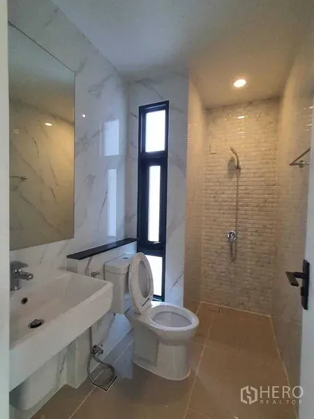 บ้าน ขายในPrawet, Bangkok - ห้องน้ำขนาดกะทัดรัด มีหน้าต่าง อ่างล้างหน้า โถสุขภัณฑ์ และมุมอาบน้ำ