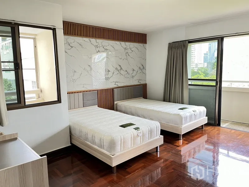 คอนโด ให้เช่าในWatthana, Bangkok - ห้องนอนเตียงคู่ ผนังหัวเตียงลายหินอ่อน และประตูกระจกออกระเบียง