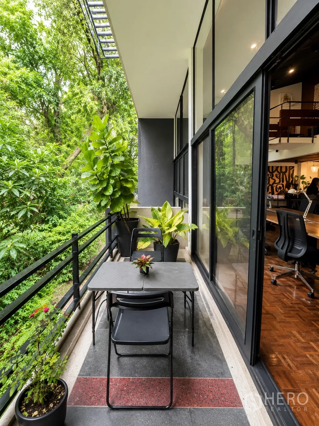 Office Space for rent in Phaya Thai, Bangkok - Balcony terrace with small table and chairs overlooking lush greenery.