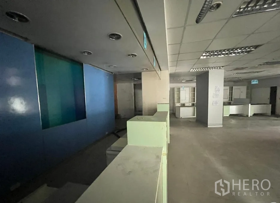 Shophouse for rent or sale in Khlong Toei, Bangkok - Service counter corridor with blue accent wall and recessed ceiling lighting.