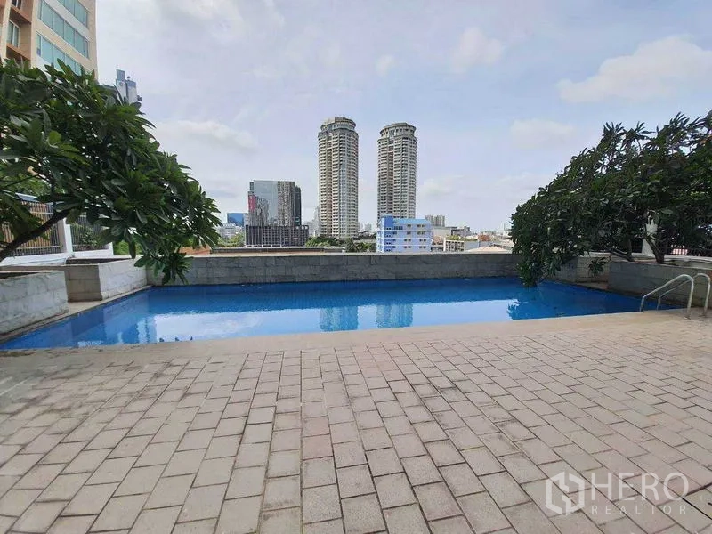Condominium for rent or sale in Sathon, Bangkok - Outdoor pool with skyline view of nearby high-rise towers and spacious pool deck.
