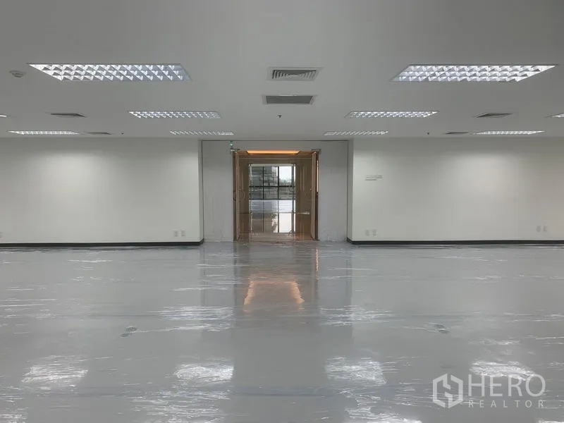 Office Space for rent in Bang Rak, Bangkok - Interior view from the office toward the lobby entrance with bright ceiling panels.