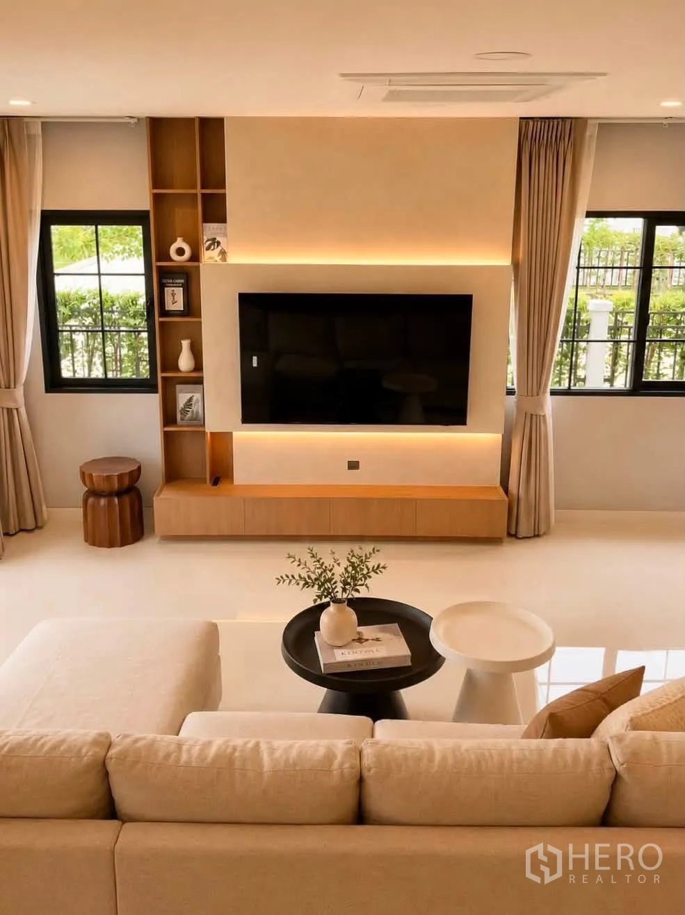 Detached House for rent in Bang Phli, Samut Prakan - TV wall with soft backlighting, built-in shelves and a large screen.