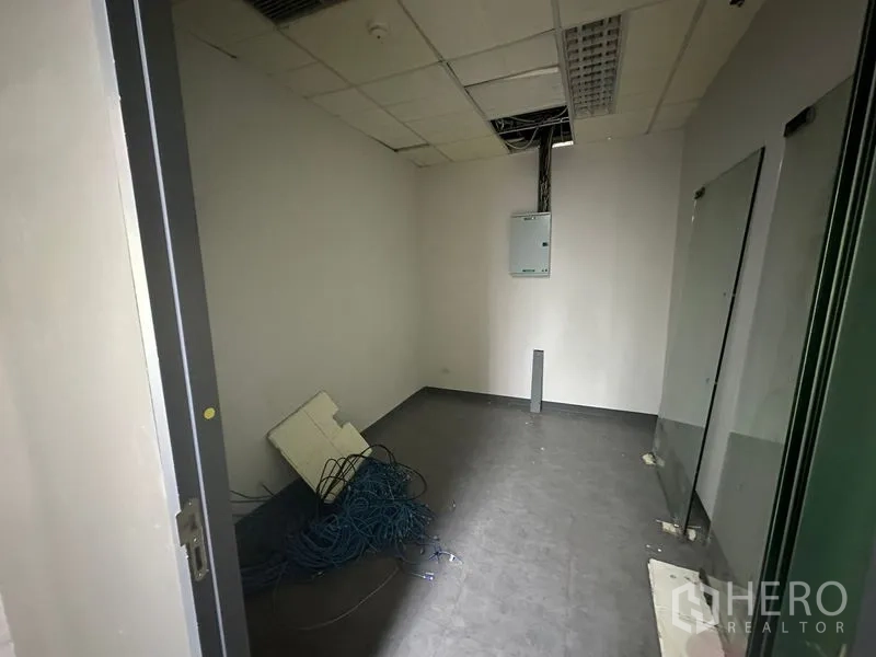 สำนักงาน ให้เช่า - ห้องไอทีหรือเซิร์ฟเวอร์ขนาดเล็ก มีตู้ไฟ สายเคเบิล และพื้นสีเข้ม