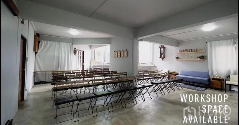 Home Office for rent in Khlong Toei, Bangkok - Multi-purpose classroom space with folding chairs, sofa seating and wide windows for training sessions.