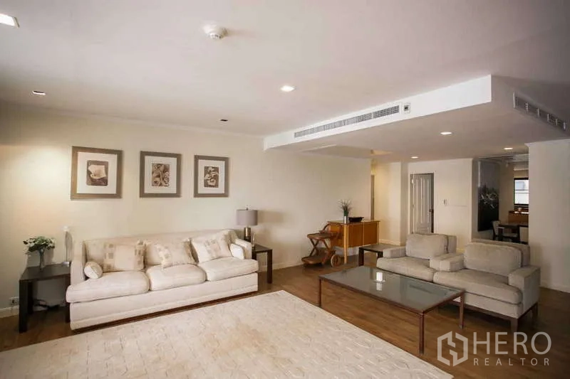 Condominium for rent or sale in Watthana, Bangkok - Large lounge with two sofas, coffee table and neutral decor.