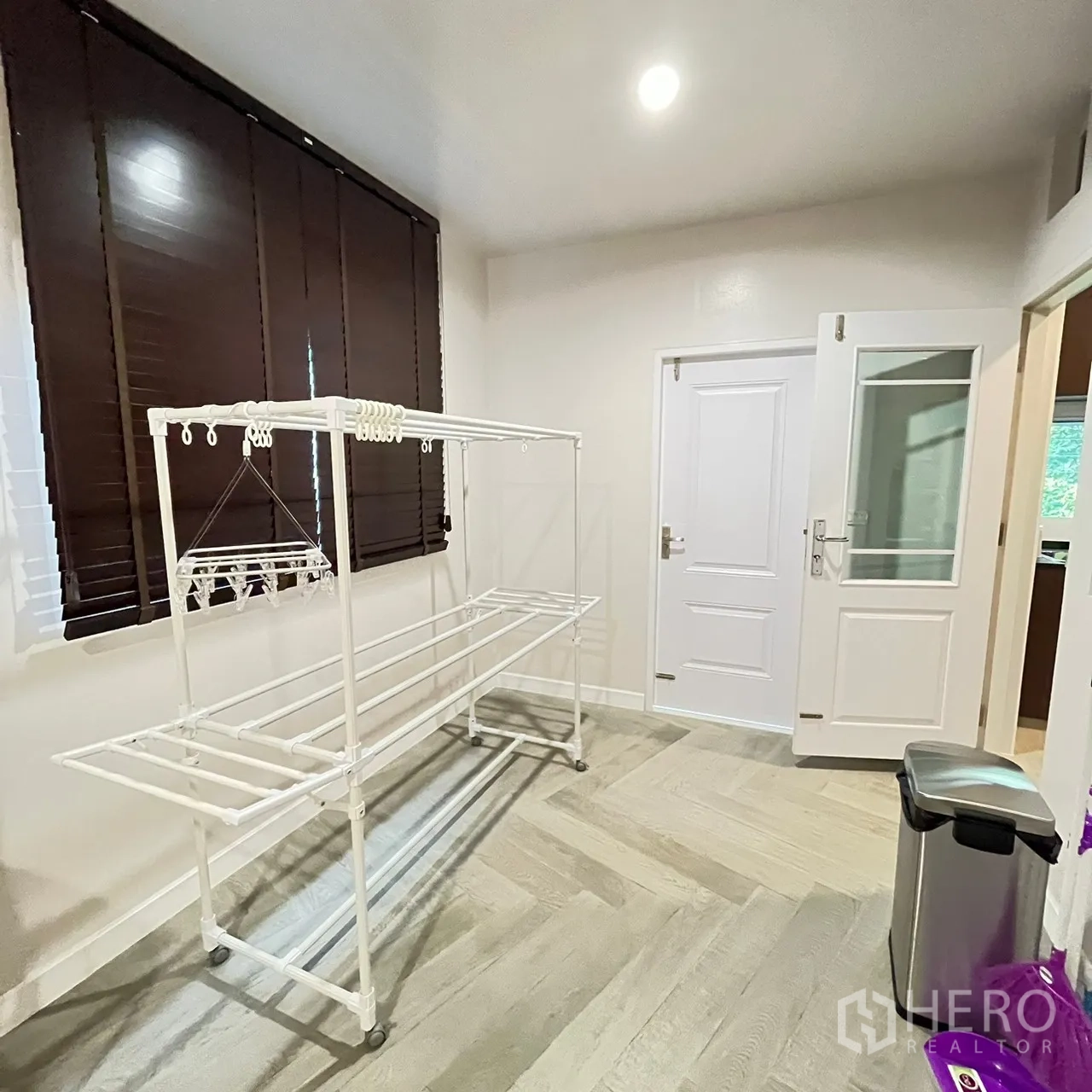 Detached House for rent or sale in Bang Khen, Bangkok - Utility room with indoor drying rack and back entry door.