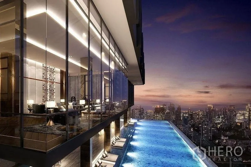 Condominium for rent in Ratchathewi, Bangkok - Skyline-view infinity pool and glass-walled lounge at dusk atop The Address Siam.