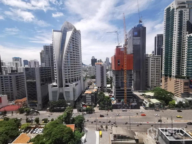 Condominium for rent or sale in Watthana, Bangkok - High‑floor skyline view of Sukhumvit with modern towers and a busy main road.