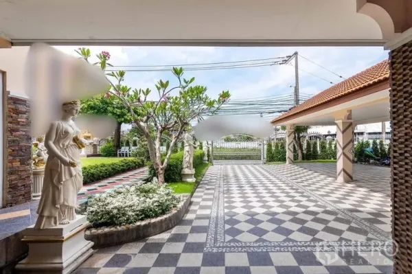 Detached House for rent or sale in Bang Khen, Bangkok - Spacious covered carport and checkered driveway with garden statues and hedges facing the front gate.