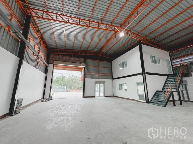 货栈 出租或出售在Khlong Luang, Pathum Thani - 仓库深景，超高卷门、天窗与宽阔混凝土地面。