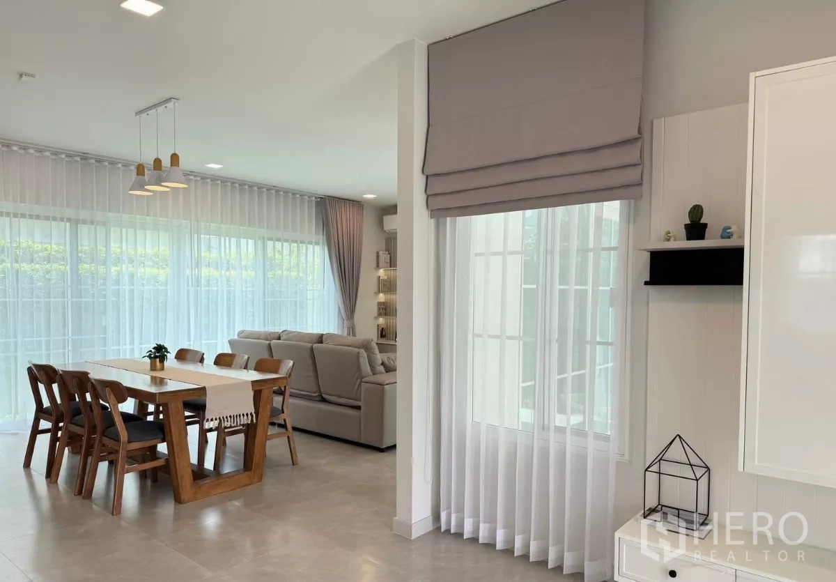 Detached House for rent or sale in Bang Phli, Samut Prakan - Dining area overlooking garden through floor-to-ceiling windows.
