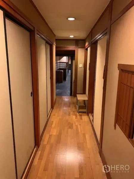 Retail Space for rent in Bang Rak, Bangkok - Wood-floored corridor with recessed lighting leading toward the main dining area.