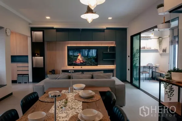 Detached House for rent or sale in Bang Phli, Samut Prakan - Lounge facing TV wall with sliding glass doors to a multipurpose room.