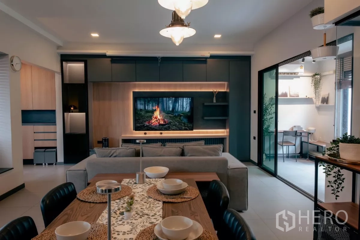 Detached House for rent or sale in Bang Phli, Samut Prakan - Lounge facing TV wall with sliding glass doors to a multipurpose room.