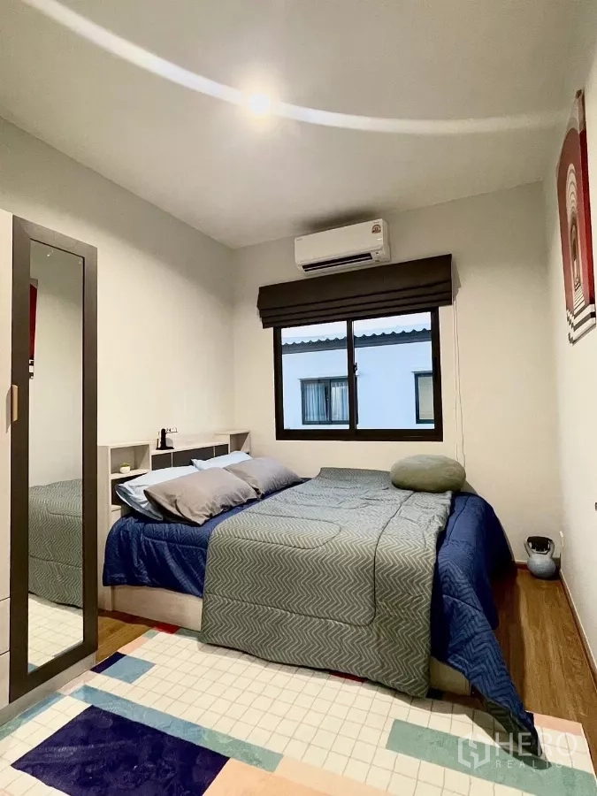 Townhouse for rent in Samut Prakan - Furnished bedroom with double bed, wardrobe and window for natural light.
