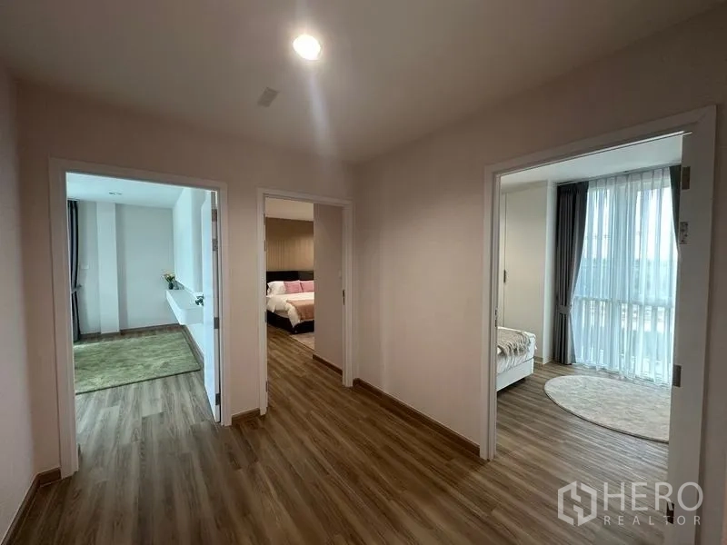 Warehouse for sale in Pathum Thani - Upper-floor corridor with wood flooring connecting multiple rooms in the staff quarters.