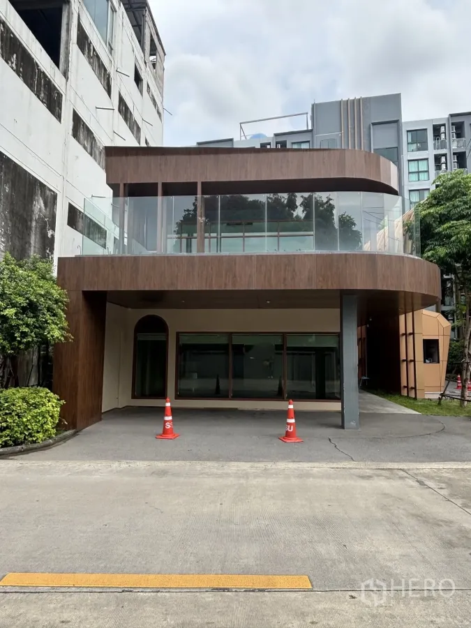 Retail Space for rent in Watthana, Bangkok - Contemporary two-storey retail building exterior with curved glass balcony and a covered forecourt.