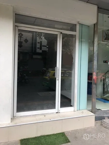 Retail Space for rent in Khlong Toei, Bangkok - Close-up of aluminum-framed sliding glass shopfront at ground level.