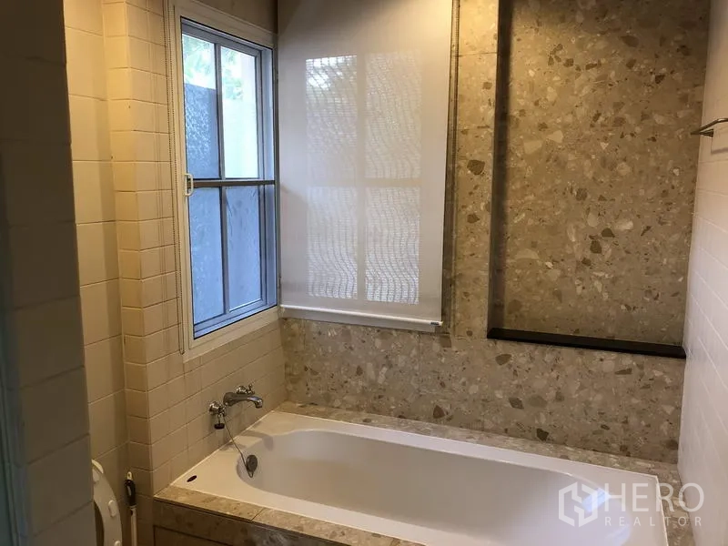 Detached House for sale in Wang Thonglang, Bangkok - Bathroom with bathtub, terrazzo wall finish, window, and roller blind.