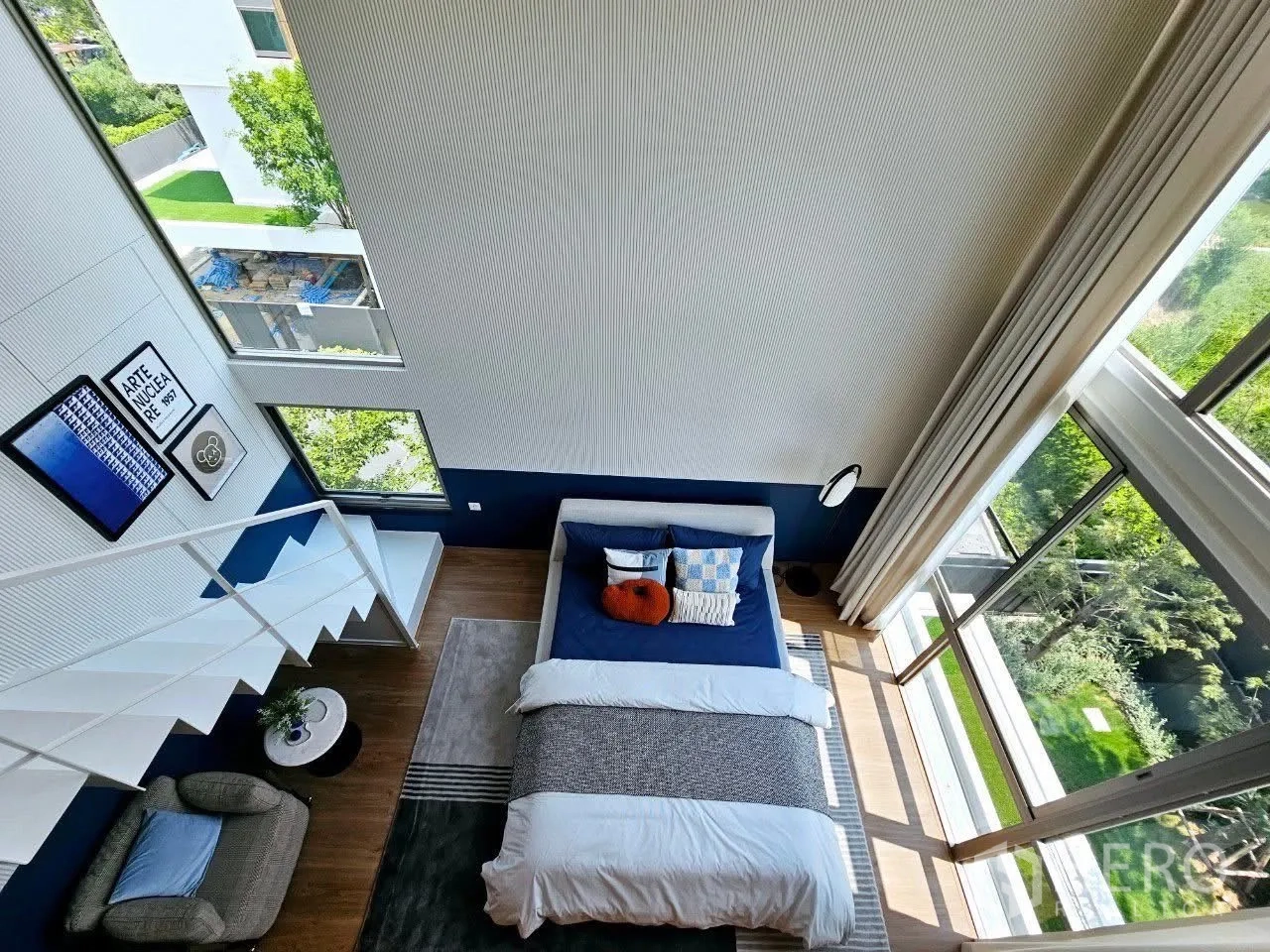 Detached House for rent in Saphan Sung, Bangkok - Aerial view of loft bedroom with expansive glazing and green views.
