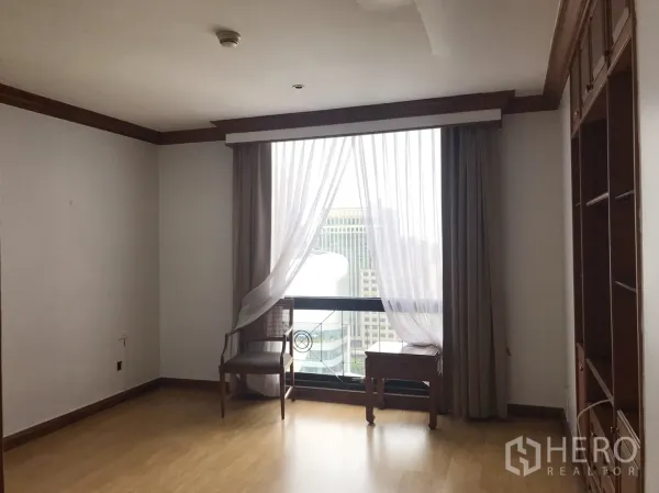 Condominium for rent in Pathum Wan, Bangkok - Corner room with floor-to-ceiling window, sheer curtains, and city skyline view.