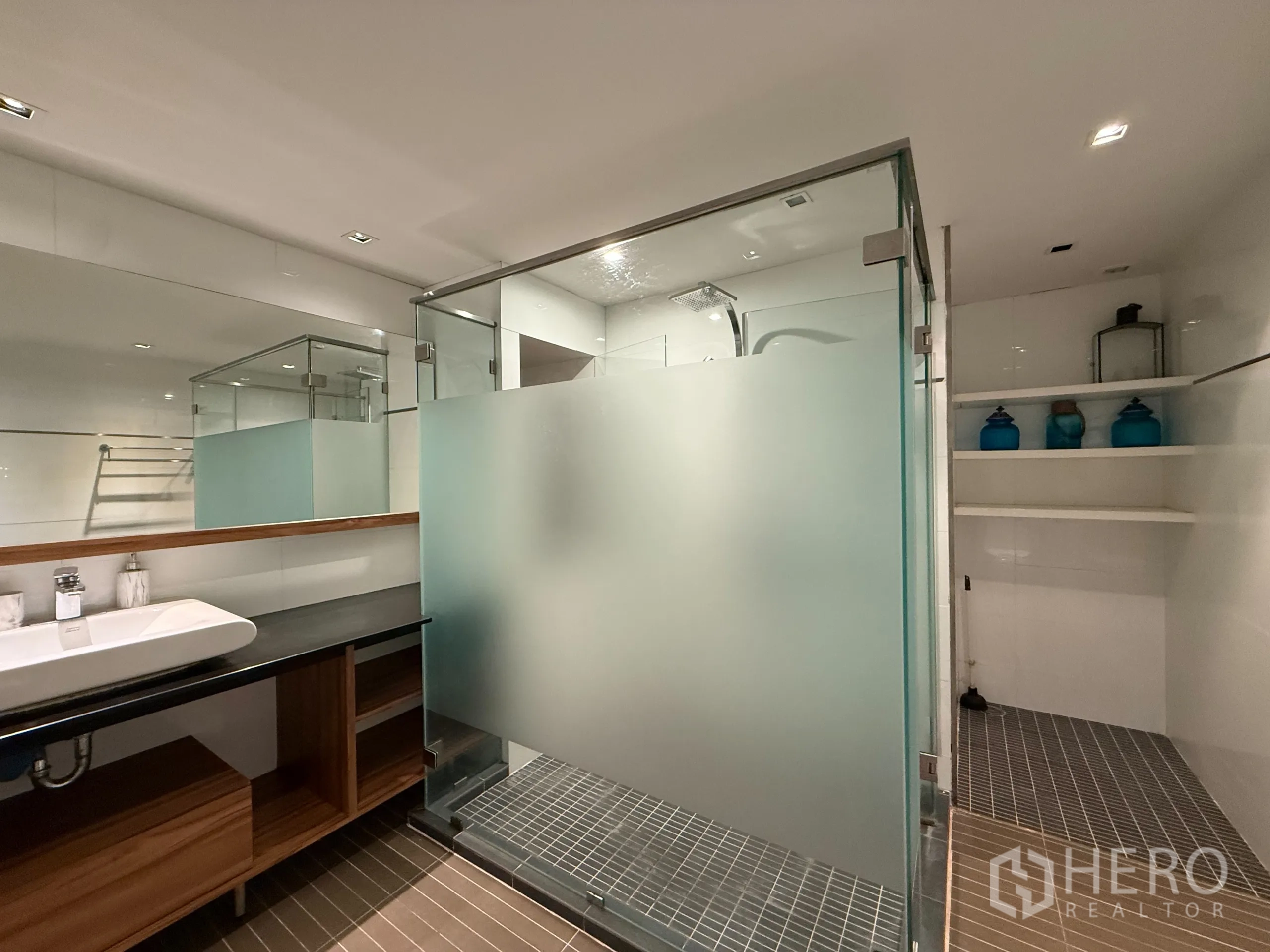 Condominium for rent in Phaya Thai, Bangkok - Large bathroom with long vanity, frosted glass shower and built‑in shelves.