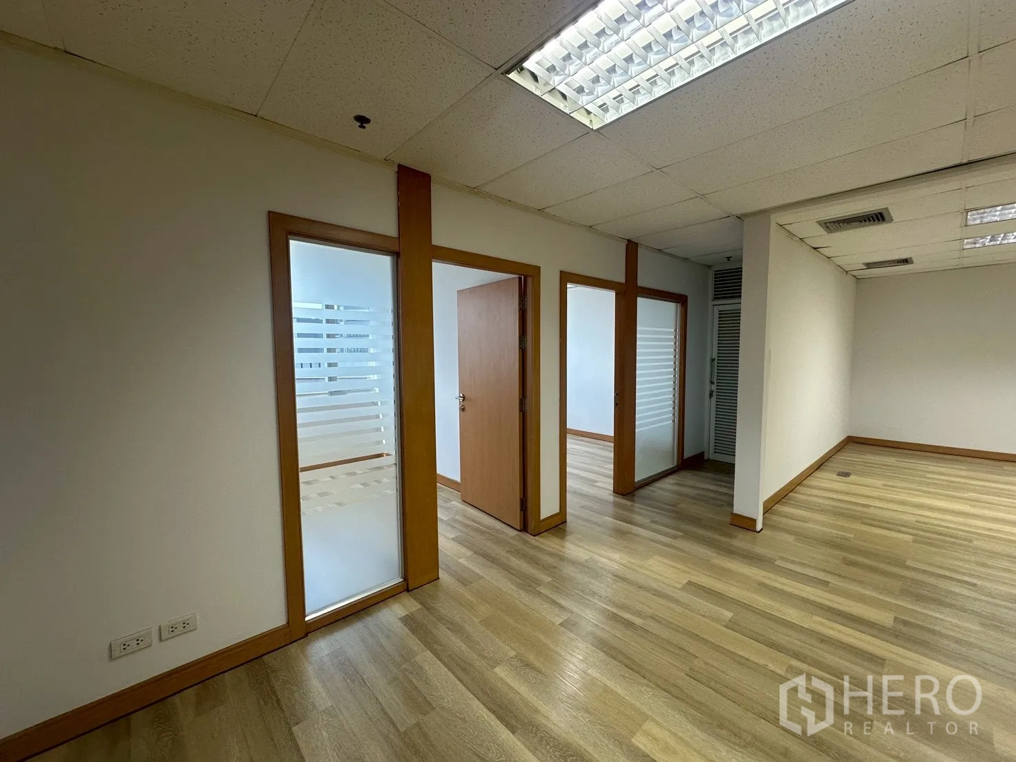 Office Space for rent - Close-up of three compact offices featuring frosted glass and wooden frames.