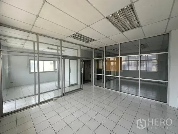 Factory for rent in Pathum Thani - Glass-partitioned office and meeting rooms inside the factory.