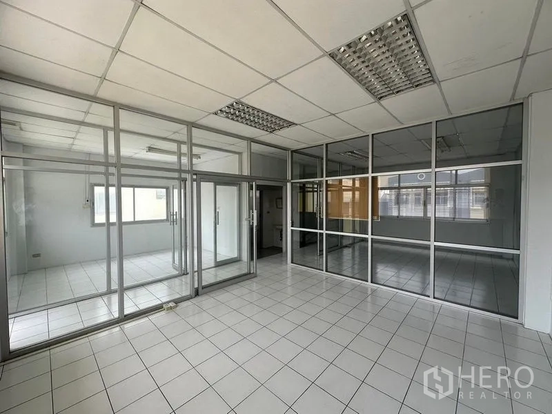 Factory for rent in Pathum Thani - Glass-partitioned office and meeting rooms inside the factory.