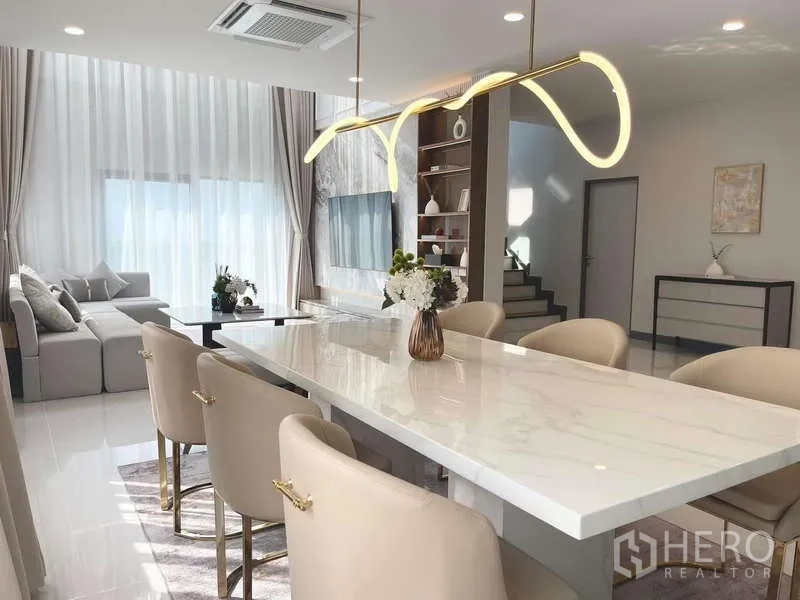Detached House for rent in Bang Phli, Samut Prakan - Open-plan dining area leading to the living room with modern lighting.