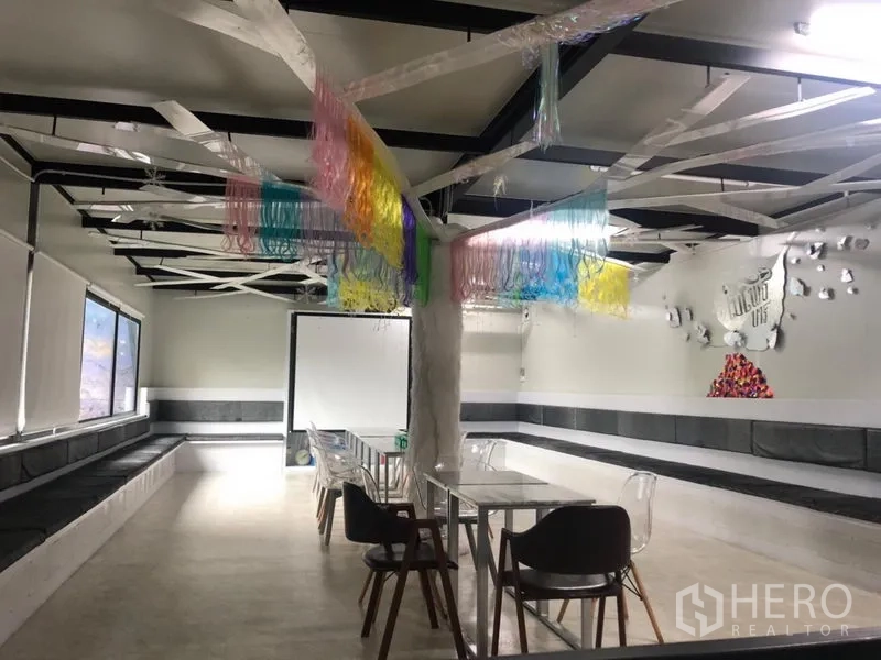 Retail Space for rent in Khlong Toei, Bangkok - Bright event space with white floors, colorful ceiling decor, and flexible seating.