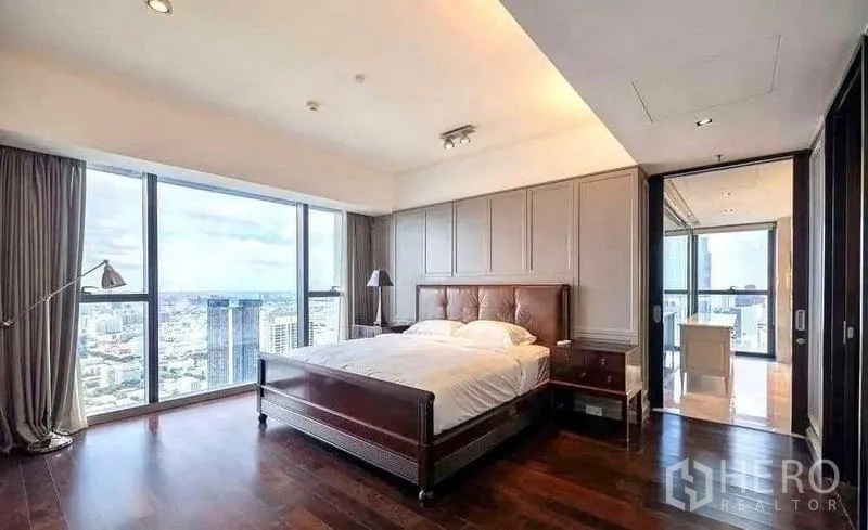 Condominium for rent - Master bedroom with city view, wood floors and leather headboard.