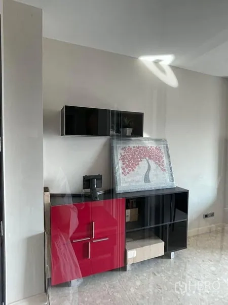 Condominium for sale in Khlong Toei, Bangkok - Contemporary storage cabinet in red and black with wall-mounted unit.