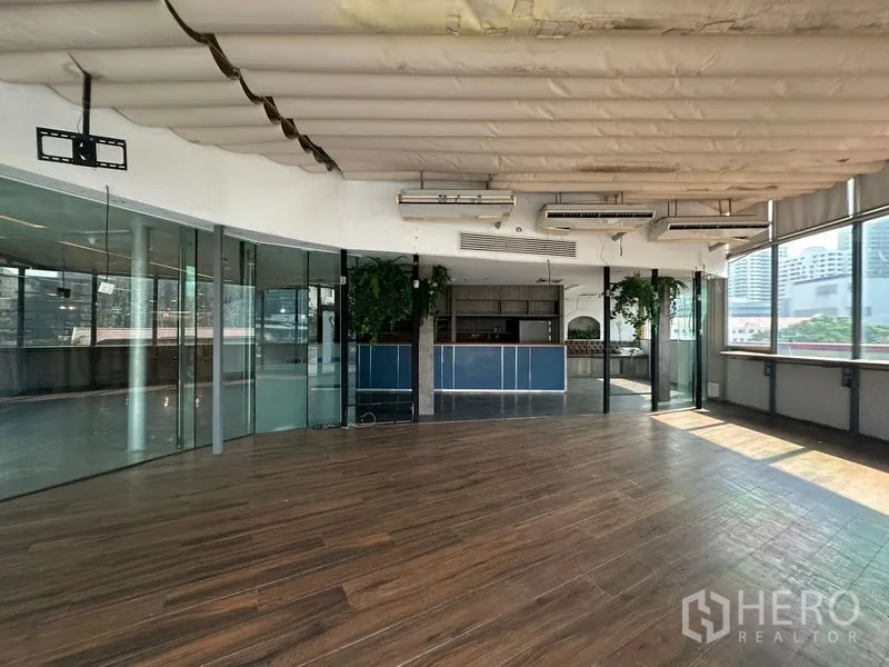 Retail Space for rent in Pathum Wan, Bangkok - Open-plan space featuring a bar counter, glass partitions, and greenery accents.