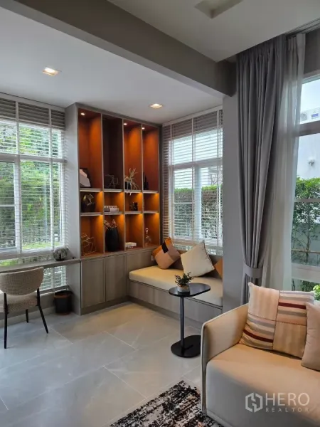 Detached House for rent in Prawet, Bangkok - Reading nook beside picture windows with warm backlit display shelves and built-in bench.
